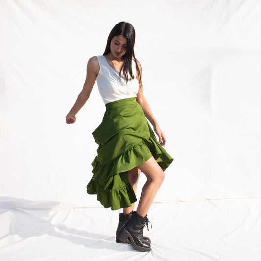 Woman wearing a white top and olive green skirt on a white background
