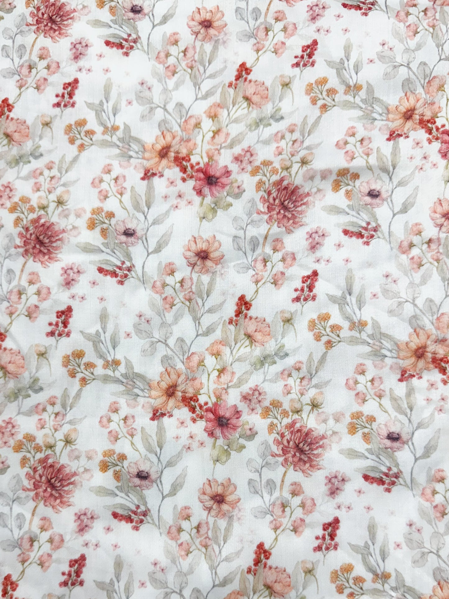 Floral patterned fabric with pink and red flowers on a white background