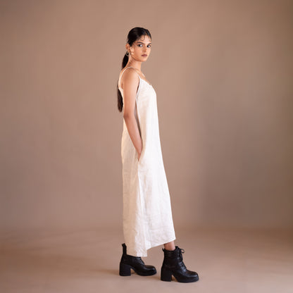Woman wearing a beige dress with cut-out design on a beige background