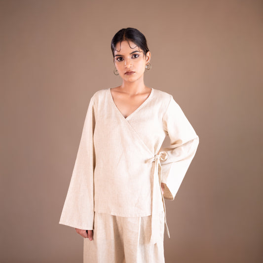 Woman wearing a beige outfit against a brown background