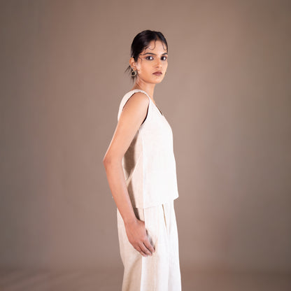 Woman wearing a white dress against a brown background