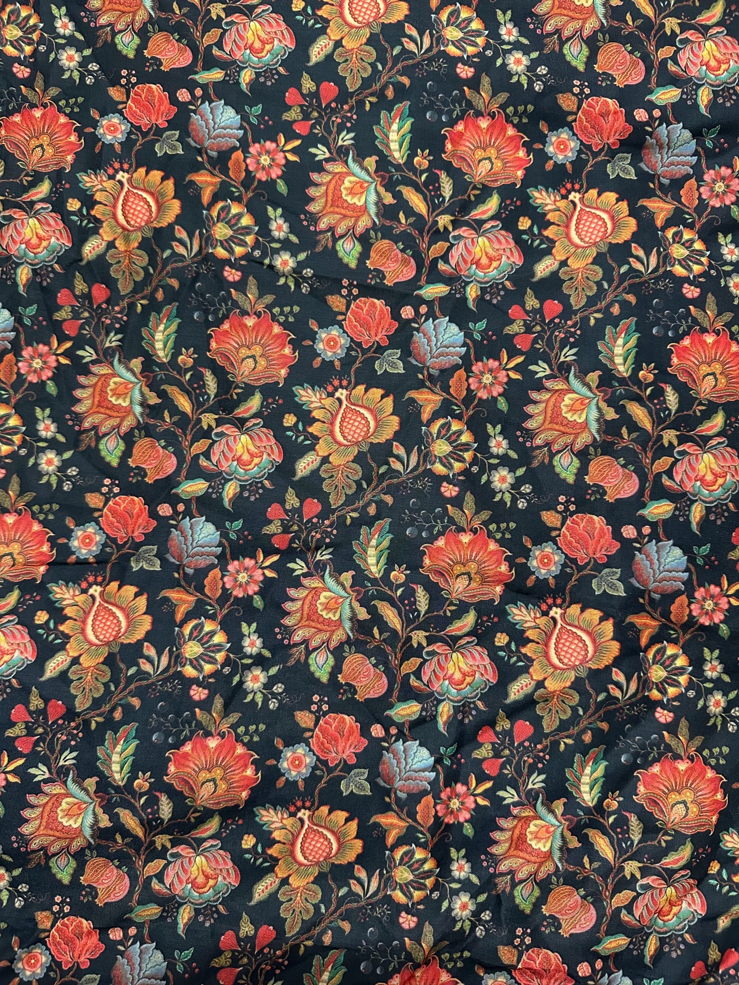 Floral patterned fabric with colorful flowers on a dark background