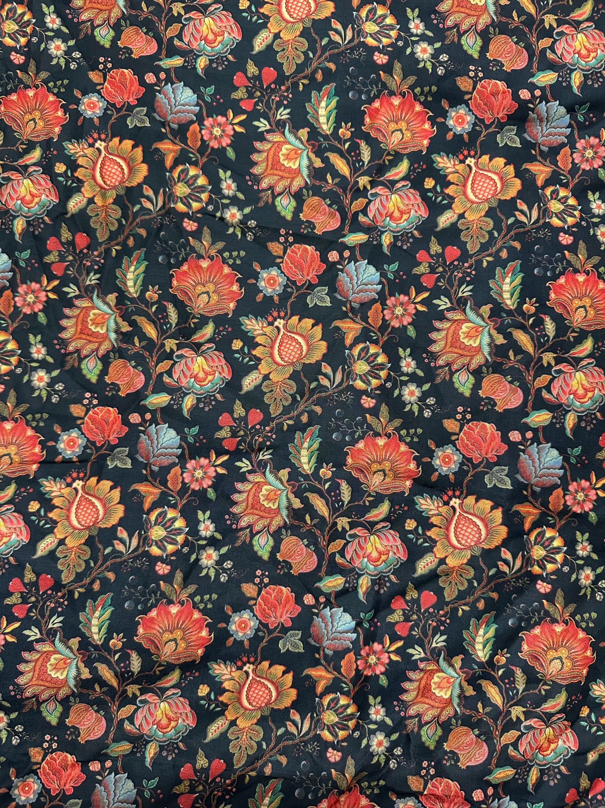Floral patterned fabric with colorful flowers on a dark background