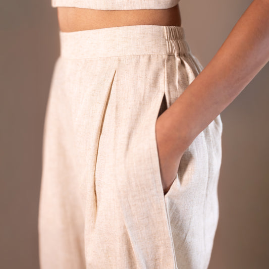 Elasticated Beige pants worn by a person on a plain background