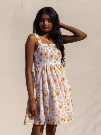 Woman wearing a floral dress against a plain background