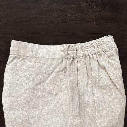 Beige pants on a dark wooden surface