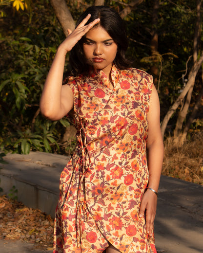 Woman wearing a floral dress standing outdoors with trees in the background