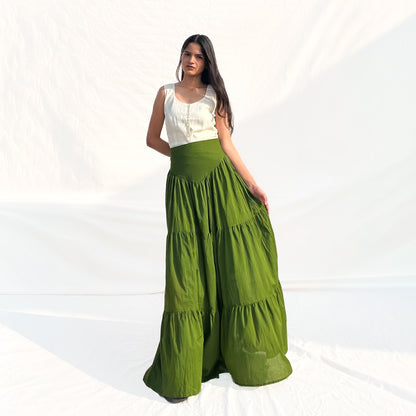 Woman wearing a white top and green skirt on a white background
