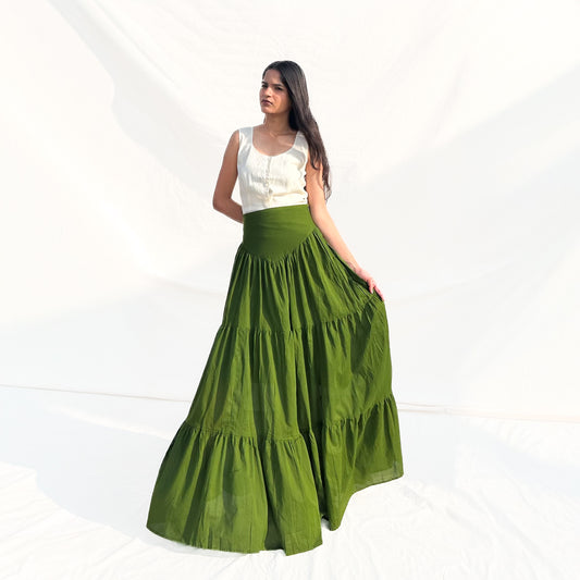 Woman wearing a white top and green skirt on a white background