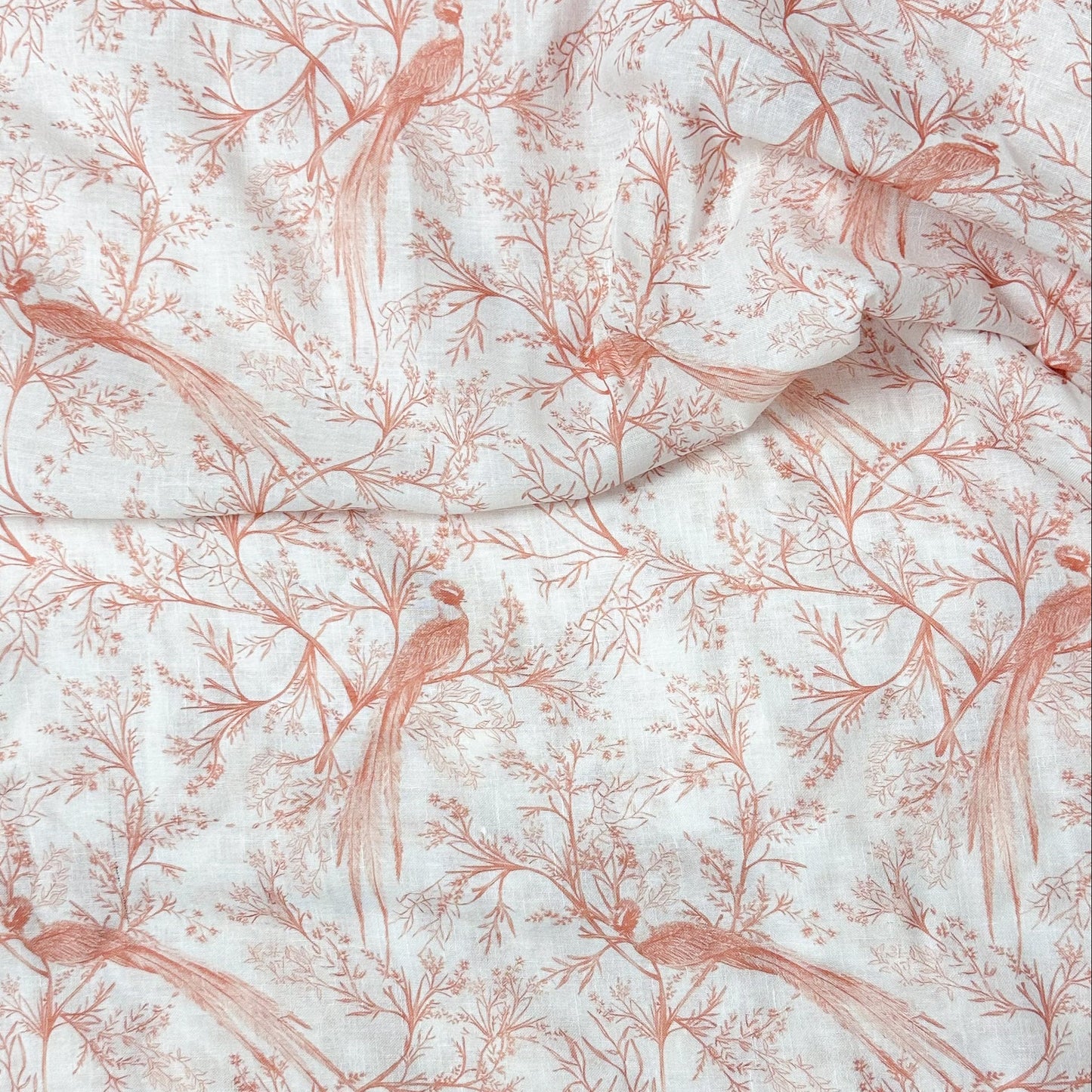 Fabric with red bird and branch pattern on white background