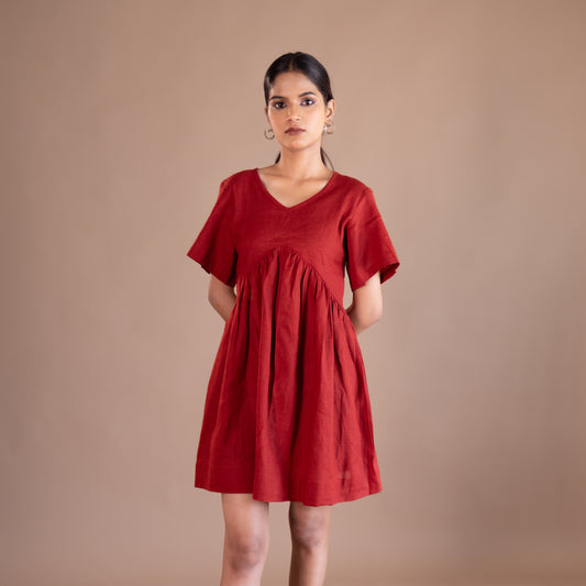Woman wearing a red dress against a brown background