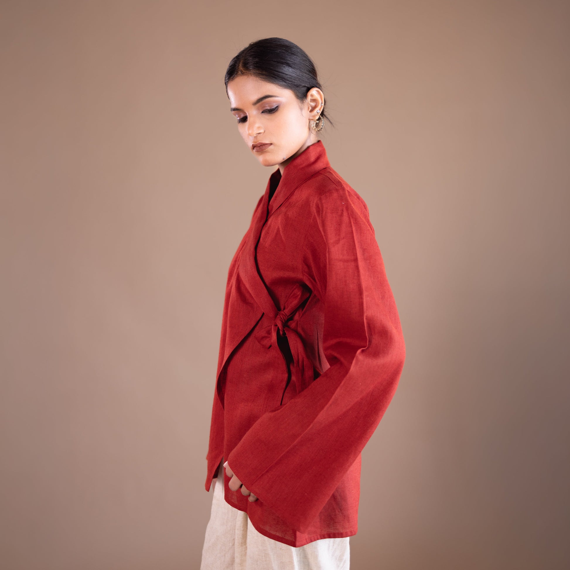 Woman wearing a red top with a plain background