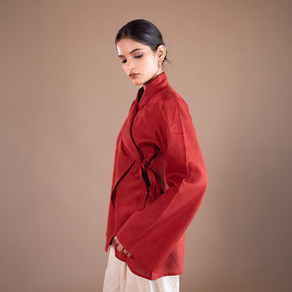 Woman wearing a red top with a plain background