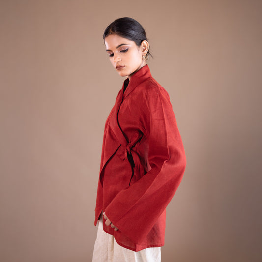 Woman wearing a red top with a plain background