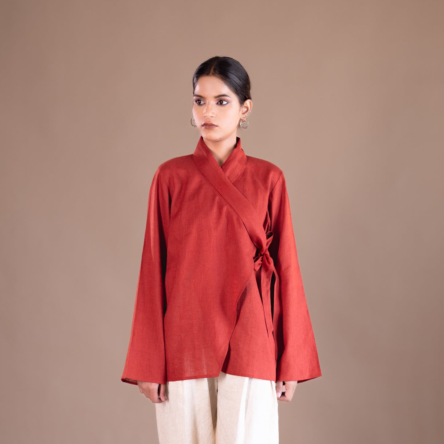 Woman wearing a red top against a brown background