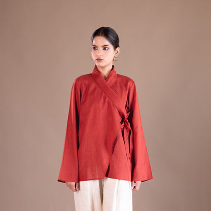 Woman wearing a red top against a brown background