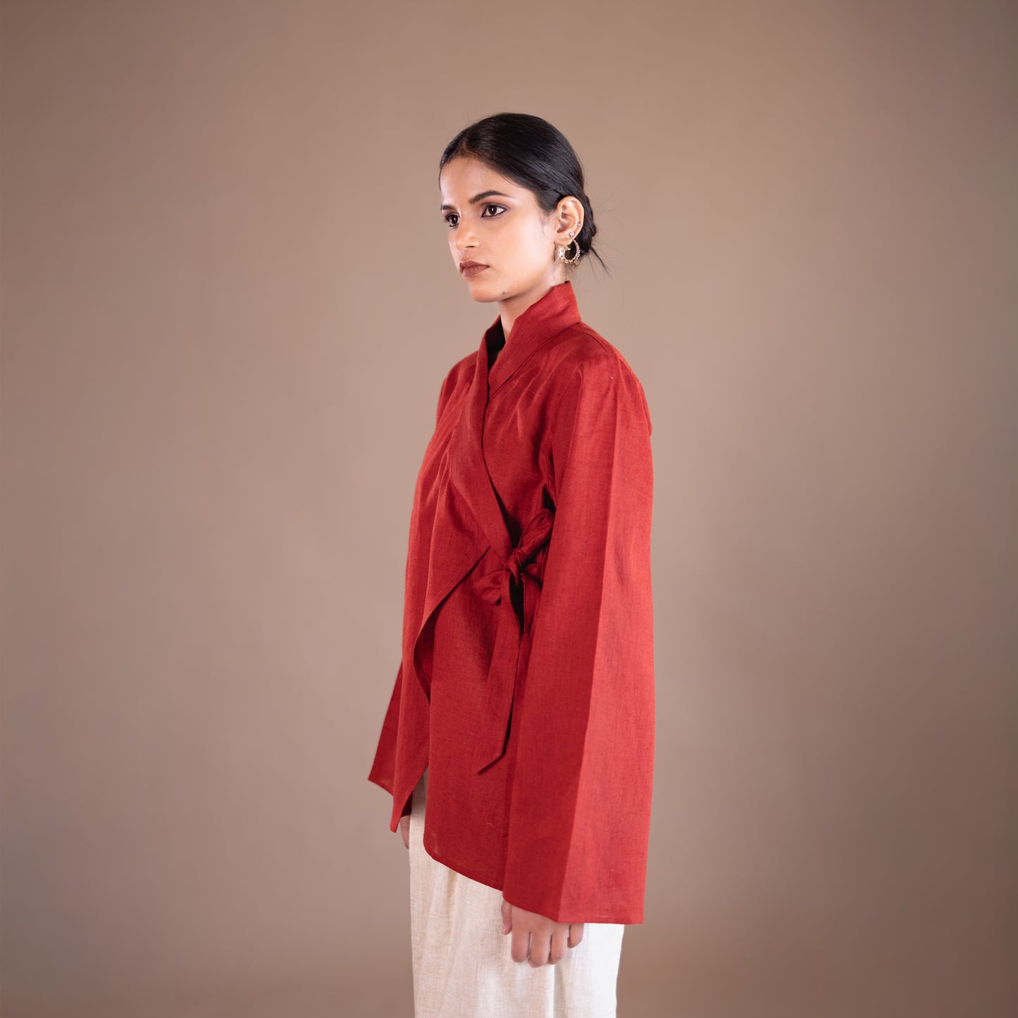 Woman wearing a red blouse against a brown background