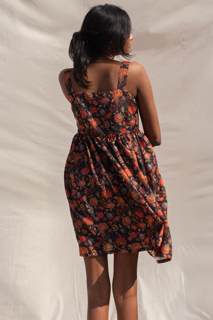 Woman wearing a floral dress with a neutral background